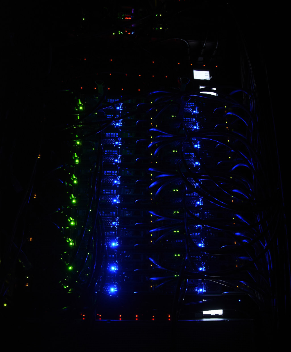 Status LEDs of the compute nodes glowing in the dark server room